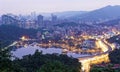 Romantic night aerial view of Da-Hu Community Park at dusk with an oriental arch bridge over the lake Royalty Free Stock Photo