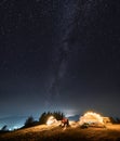 Romantic nightly camping in mountains under starfull sky.