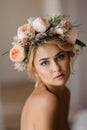 Romantic topless look of attractive blonde woman in a floral wreath