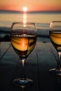 Romantic outdoor activity. Two glasses with white wine in an outdoor restaurant with sunset sea view, relaxation concept for two Royalty Free Stock Photo