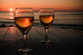 Romantic outdoor activity. Two glasses with white wine in an outdoor restaurant with sunset sea view, relaxation concept for two Royalty Free Stock Photo