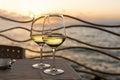 Romantic outdoor evening with two glasses of white wine and beautiful sunset Royalty Free Stock Photo