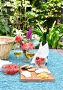 Romantic patio setting for relaxing warm summer evening outdoor picnic in beautifully landscaped garden Royalty Free Stock Photo