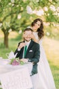 Romantic picknick in park. Playful bride shutting eyes of her lovely new husband Royalty Free Stock Photo