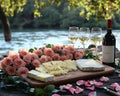 Romantic Wine and Cheese Picnic by the River with Roses Royalty Free Stock Photo