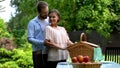 Romantic picnic in country house, husband embracing wife, happy tender family