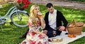 Romantic picnic date with wine. Enjoying their perfect date. Happy loving couple relaxing in park. Couple in love Royalty Free Stock Photo