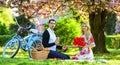 Romantic picnic with wine. Flowers symbol of romance and affection. Enjoying their perfect date. Couple relaxing in park