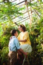 Romantic picture of lovely couple on a date in greenhouse. Happy man and woman spending time together. Valentine's Day.