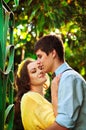 Romantic picture of lovely couple on a date in greenhouse. Happy man and woman spending time together. Valentine's Day.