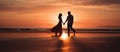 Romantic picture of Silhouettes of young couple on the beach at sunset.