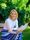 Romantic poem. Enjoy rhyme. Woman happy smiling blonde take break relaxing in garden reading poetry. Girl sit bench