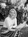 Romantic poem. Enjoy rhyme. Woman happy smiling blonde take break relaxing in garden reading poetry. Girl sit bench