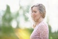 Romantic portrait of a beautiful elderly woman. Mature beautiful blonde in a pink dress Royalty Free Stock Photo