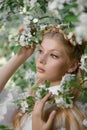 Romantic portrait of a girl in the park near a blooming apple tree. Natural cosmetics. Natural beauty of a woman in a white dress Royalty Free Stock Photo