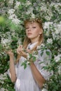 Romantic portrait of a girl in the park near a blooming apple tree. Natural cosmetics. Natural beauty of a woman in a white dress Royalty Free Stock Photo