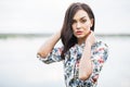 romantic portrait of young beautiful girl with long hair on water and lake background. Royalty Free Stock Photo