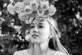 Romantic portrait of young pretty beautiful woman with long hair posing between pink roses. black and white Royalty Free Stock Photo