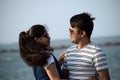 Romantic pose of a young couple at the blue sea beach. Closeup of a man and woman looking at each other as a sign of love forever Royalty Free Stock Photo