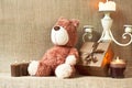 Romantic present. Teddy bear toy with gift box and candles. Royalty Free Stock Photo