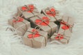 Romantic presents set. Gift boxes wrapped in brown craft paper and tie hemp string. Carton hearts. White fur background. Royalty Free Stock Photo