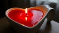 Romantic red heart shaped candle burning brightly Royalty Free Stock Photo