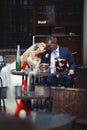 Romantic relaxed newlywed couple sitting at restaurant table