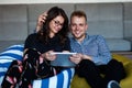 Romantic relaxed young couple using tablet computer on sofa Royalty Free Stock Photo