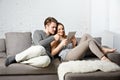 Romantic relaxed young couple using tablet computer on sofa Royalty Free Stock Photo