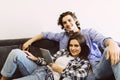 Romantic relaxed young couple using tablet computer on sofa at home Royalty Free Stock Photo