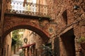 Romantic restaurants in a street of Massa Marittima. An alley with restaurant signs and tables with chairs