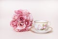 Romantic rose flower bouquet with antique tea cup with saucer Royalty Free Stock Photo