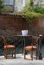 Romantic scenary, table with two chairs, two glasses of wine and a bottle of wine