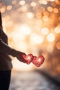 A romantic scene of a couple holding hands with a blurred heart-shaped bokeh in the background