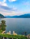 Romantic scenery of the couple having dinner under lanterns and enjoying magnificent view of Lake Como in Varenna, Italy. Royalty Free Stock Photo