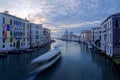 Romantic scenery of Venice, an amazing city in Italy, with tourist boats cruising on Grand Canal and landmark cathedral Basilica Royalty Free Stock Photo