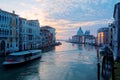 Romantic scenery of Venice  an amazing city in Italy  with tourist boats cruising on Grand Canal and landmark cathedral Basilica Royalty Free Stock Photo