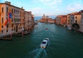 Romantic scenery of Venice at sunset, with boats, ferries & gondolas cruising on Grand Canal & the majestic landmark building