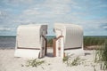 Romantic sea scene at white beach with beach chair at summer sunny day in north Germany