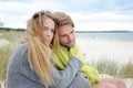 Romantic seaside couple relaxing in sand dune - autumn, beach Royalty Free Stock Photo