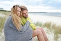 Romantic seaside lovely couple in sand dune - autumn, beach Royalty Free Stock Photo