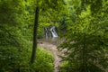 Romantic secluded place. Hidden waterfall in quiet green mountain forest