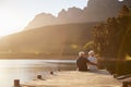Romantic Senior Couple Sitting On Wooden Jetty By Lake Royalty Free Stock Photo
