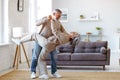 Romantic senior family couple wife and husband dancing to music together in living room Royalty Free Stock Photo