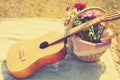 Romantic set, acoustic guitar, basket with wine, bouquet flowers on plaid. Romance, love, date, Valentines day concept Royalty Free Stock Photo