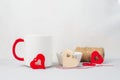 Romantic set for Valentine\'s Day concept. Wooden red hearts white cup decorations stuff for gifts light background. Royalty Free Stock Photo