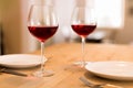 Romantic setting, two glasses of red wine on a dinner table Royalty Free Stock Photo