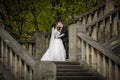 Romantic shot of newlywed husband and wife kissing on old staircase outdoors Royalty Free Stock Photo