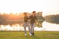 Romantic, social dance and people concept - young couple dancing bachata on the background of sunset Royalty Free Stock Photo