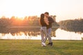 Romantic, social dance and people concept - young couple dancing bachata on the background of sunset Royalty Free Stock Photo